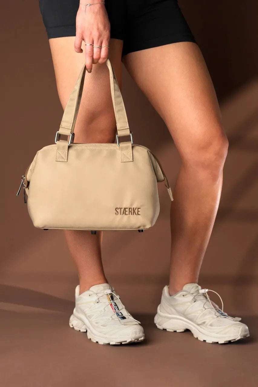 Mini beige gym bag with top handles and side zipper pocket