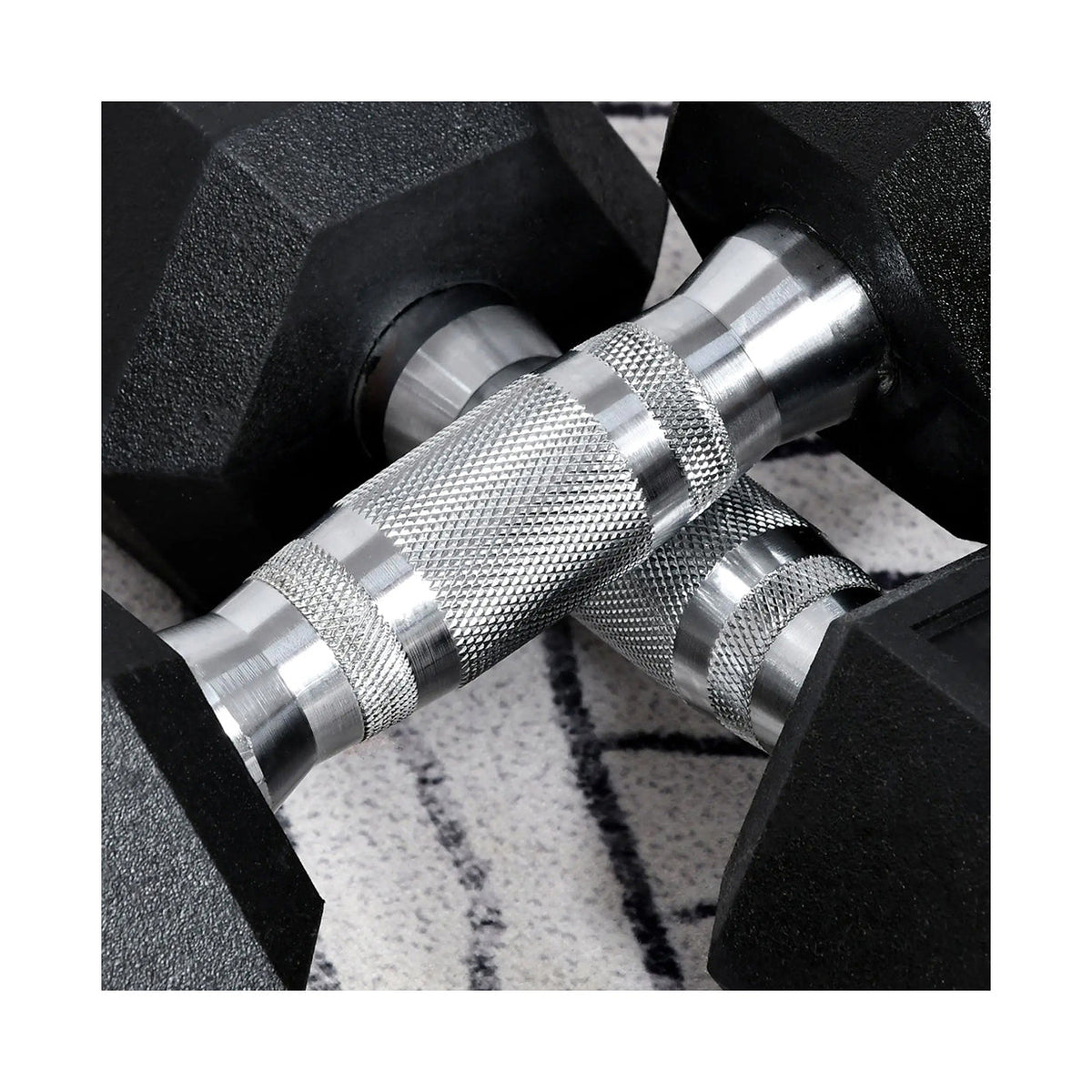 Rubber-coated hex dumbbell pair, close-up of black hex heads and chrome knurled handles
