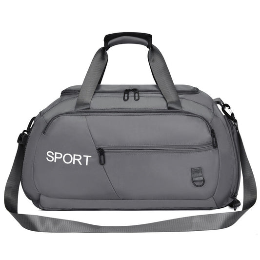 Sports duffel bag with shoe compartment, grey, front zipper pocket and two side handles.