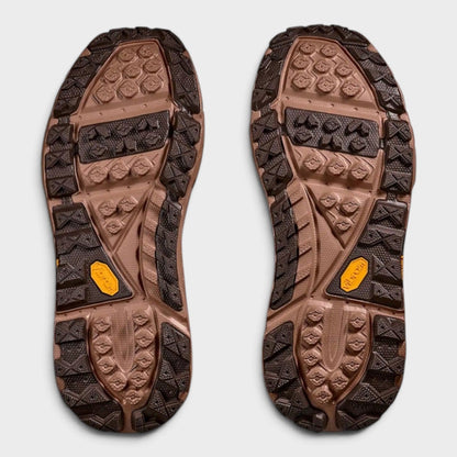 Pair of brown rubber outsoles with deep tread and embossed traction patterns