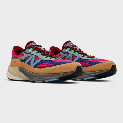 Pair of tan, blue, and red lace-up running shoes with chunky midsoles