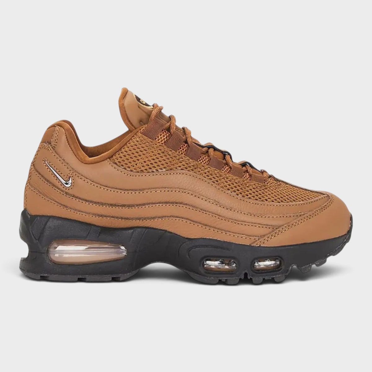 Tan Air Max 95 sneakers with mesh upper, lace-up front, and visible air unit windows