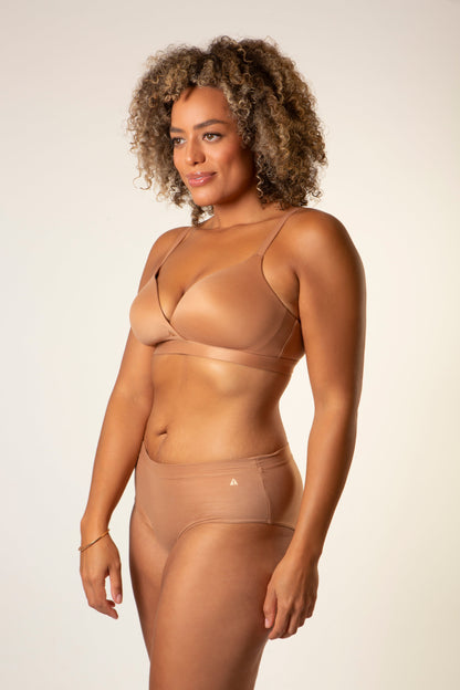 Warm tan cross-over style bra with thin straps and seamless cups
