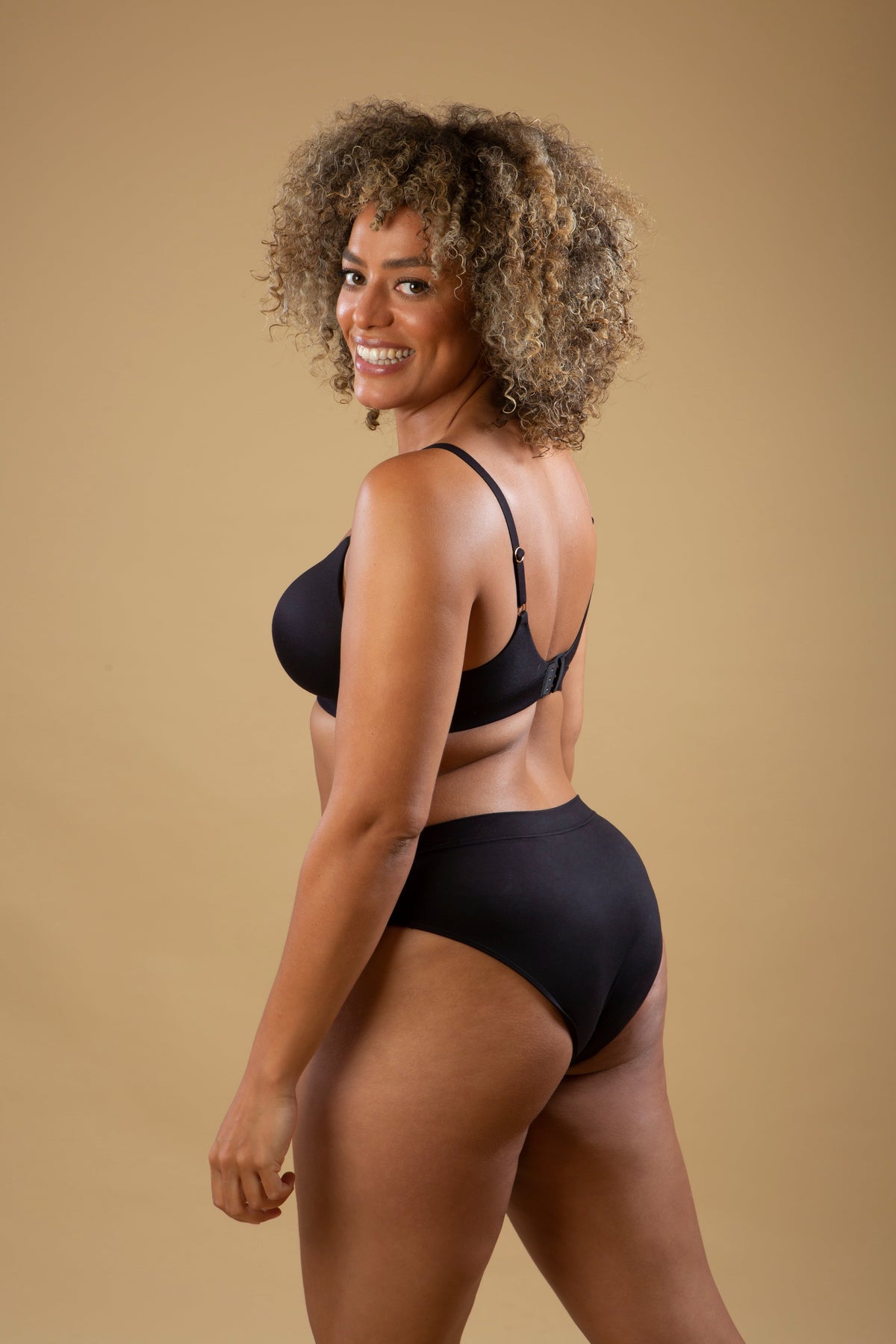 Black mid-rise briefs shown from the side with smooth waistband