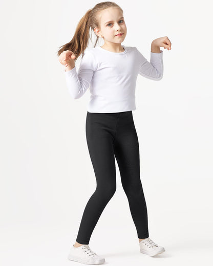 Girls' black cotton leggings, full length on model with white sneakers