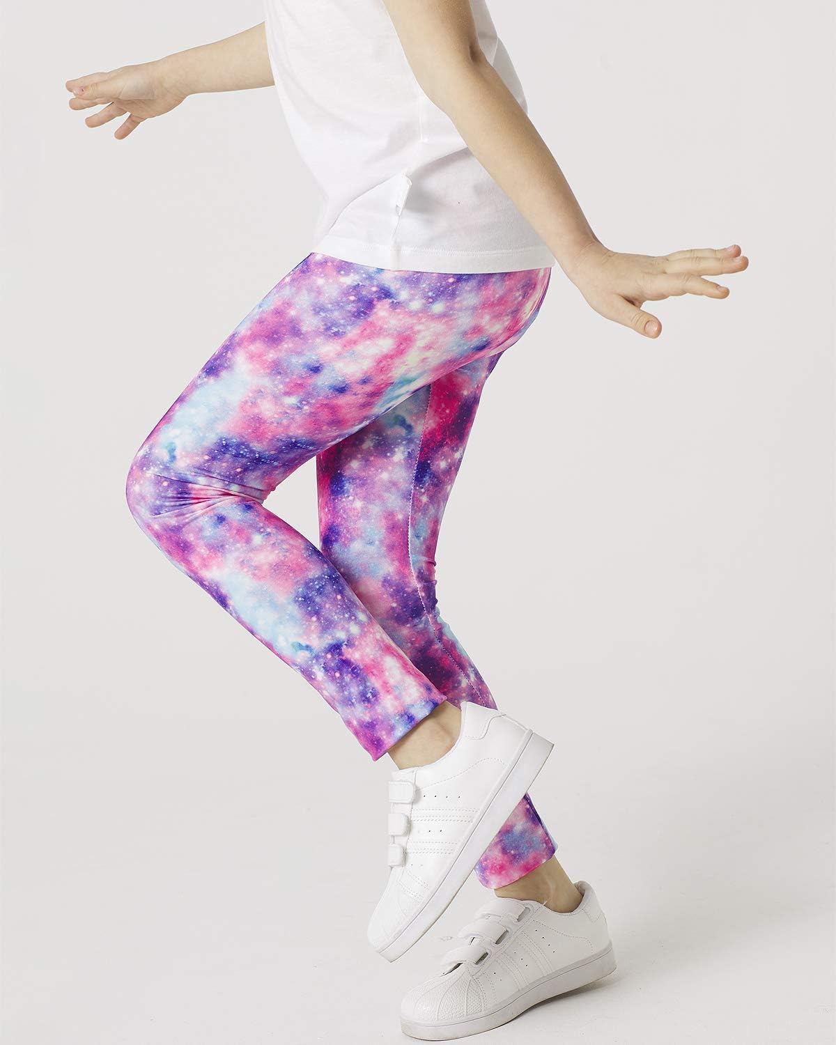 Girls' galaxy leggings in multi-color nebula print with white sneakers and white shirt
