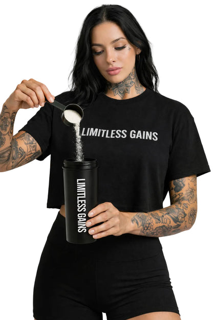 Black protein shaker bottle held by a person with lid open