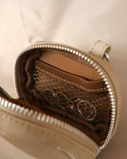 Espresso-brown zip jewelry pouch with interior patterned lining and silver zipper hardware