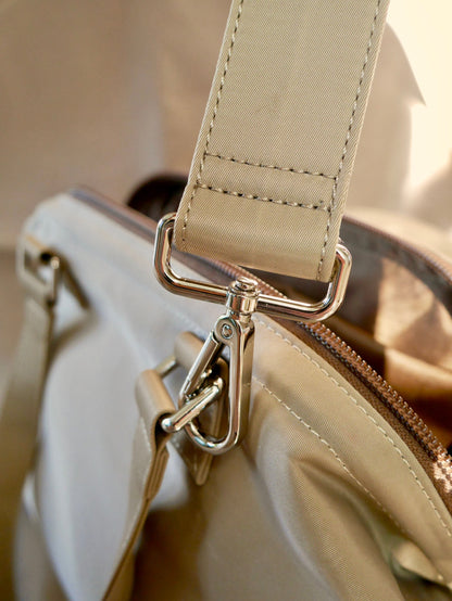 Light beige strap end with metal swivel clips and stitched fabric loop
