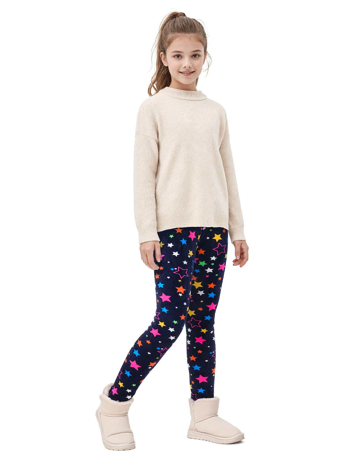 Girls fleece-lined leggings with navy and multicolor star pattern, worn with light top