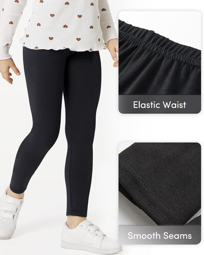 Girls black cotton leggings close-up, elastic waistband and smooth seam stitching
