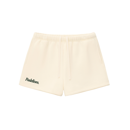 Light cream shorts with elastic waistband, drawstring, and logo patch on left leg