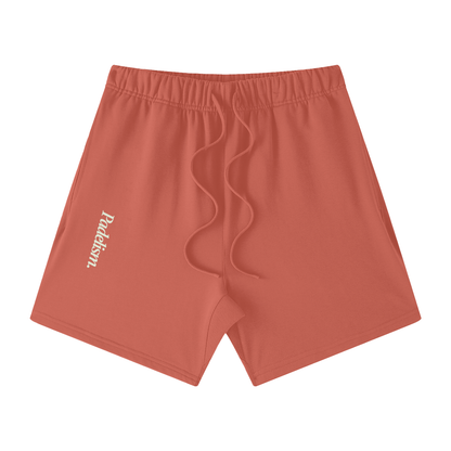 Rust red off-court shorts with elastic waistband, visible drawstring, and logo