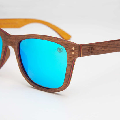Wood-look sunglasses close-up with blue mirrored lenses and brown frame details