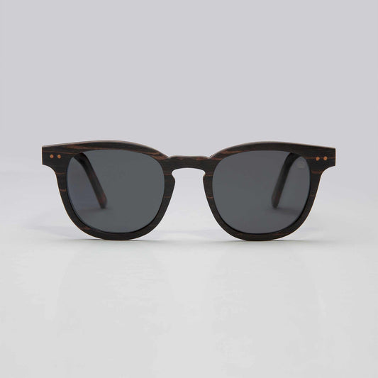 Round cat-eye sunglasses with dark tortoise frame and black tinted lenses
