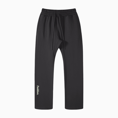 Black straight-leg pants with elastic waistband, side tie, and Padelism logo
