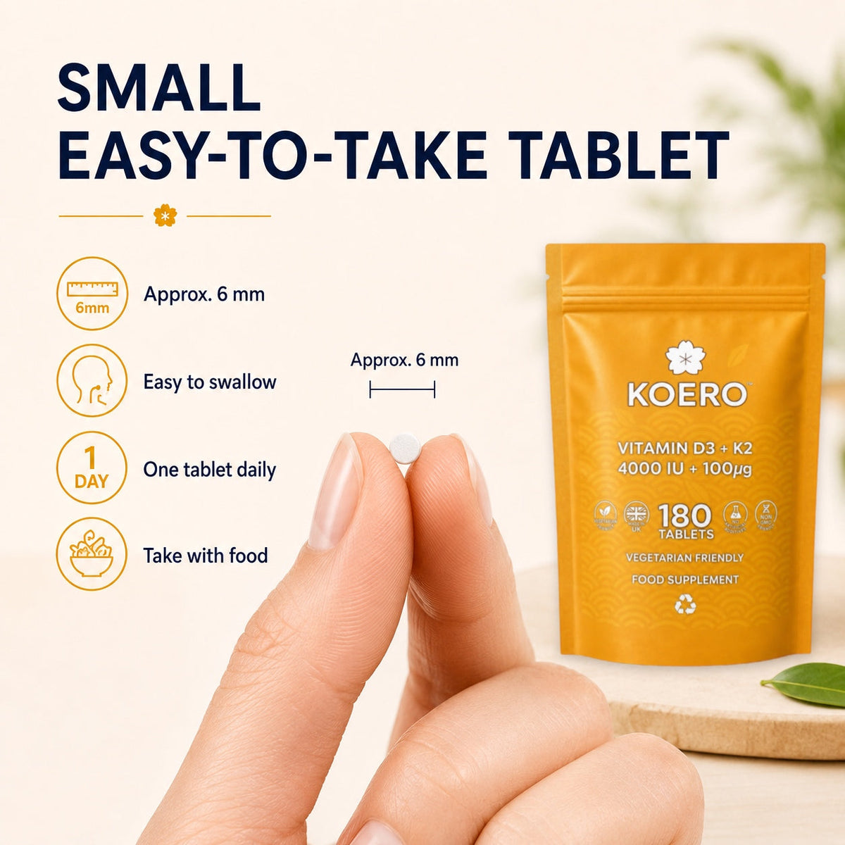 KOERO Vitamin D3 + K2 supplement pouch with small tablet size detail and hand holding tablet