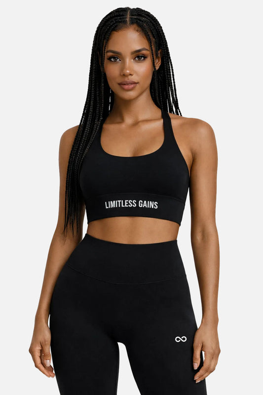 Black sports bra and high-rise leggings set with “Limitless Gains” logo on front