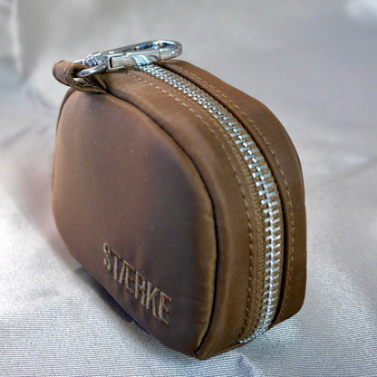 Espresso-brown zip jewelry pouch with silver zipper around the rounded front