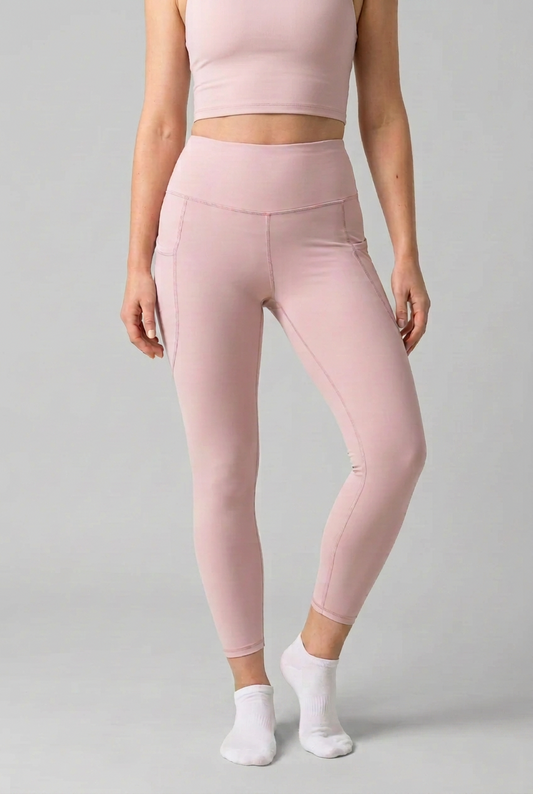 Blush pink high-rise pocket leggings with contour seams and fitted ankle length