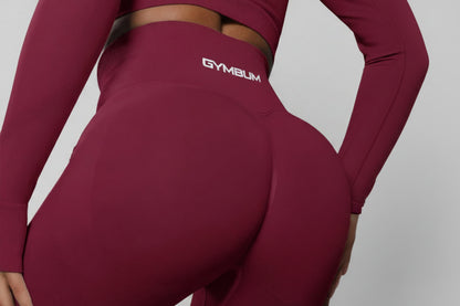 Maroon athletic outfit with 'GYMBUM logo on a dark background