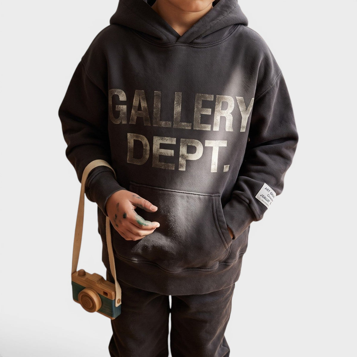 Kids black pullover hoodie worn, large front logo and kangaroo pocket