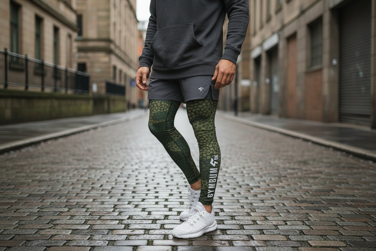 Person wearing green camouflage leggings on a white background