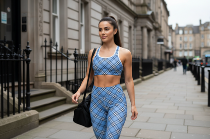 Woman in blue plaid athletic wear walking on a city street.