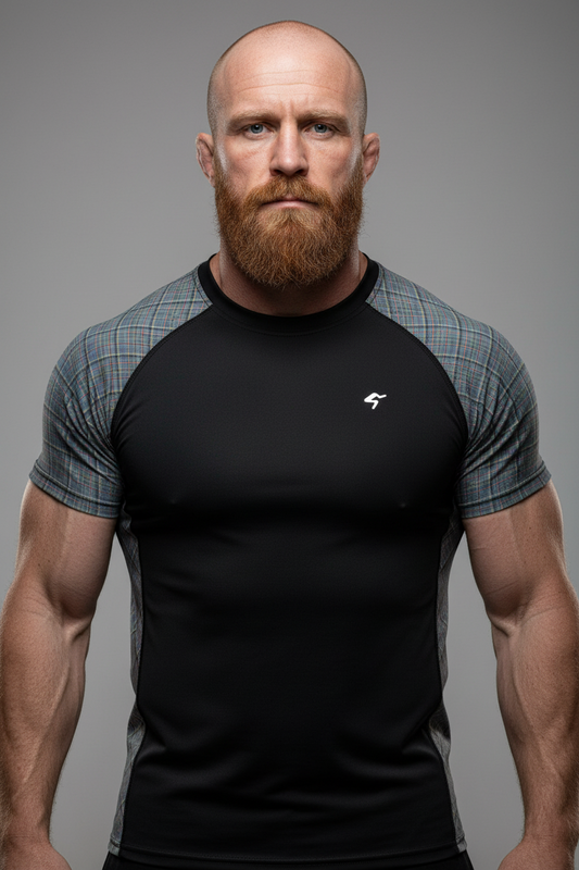 Man wearing a black and gray athletic shirt with a logo on a gray background