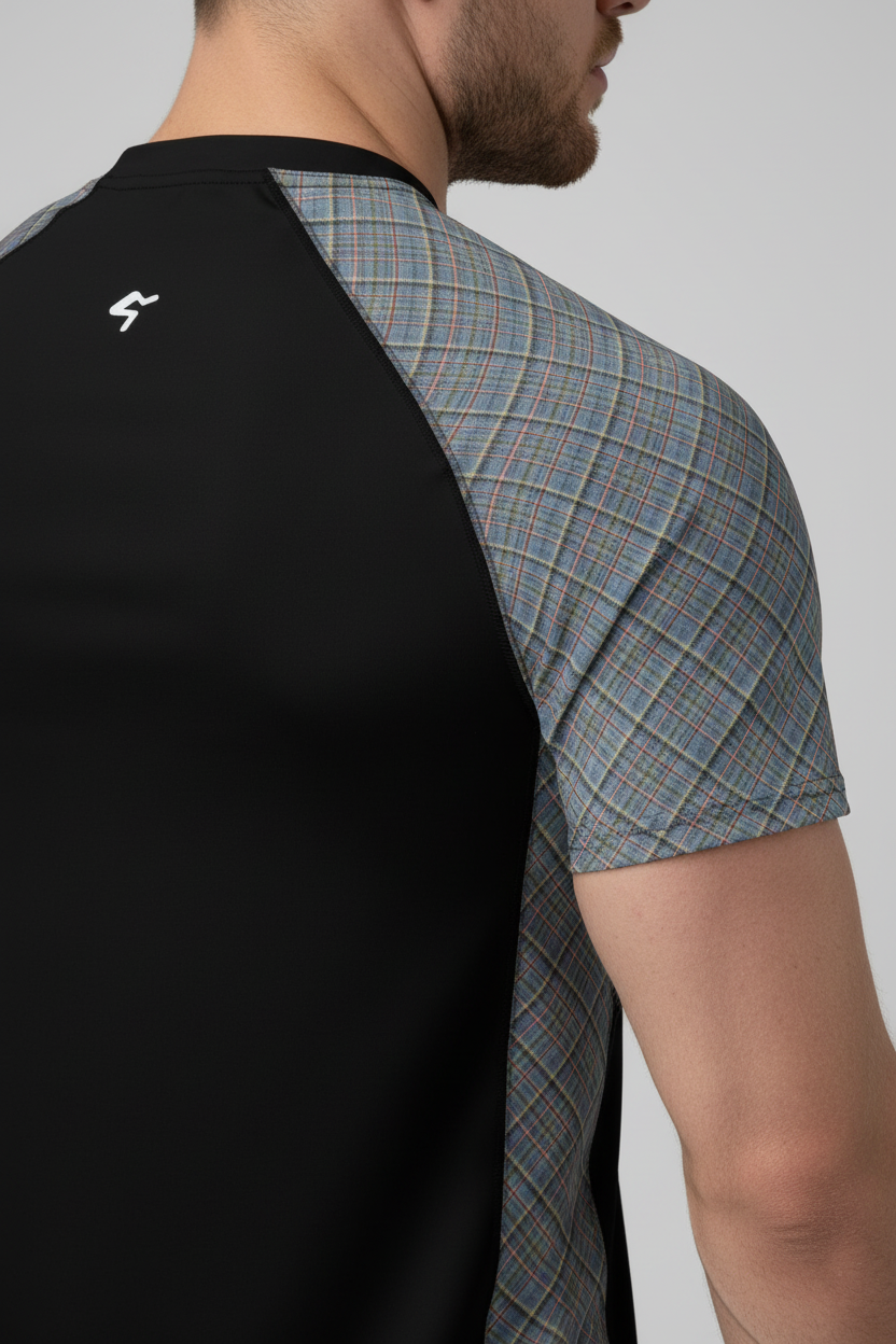 Black and plaid short-sleeve shirt worn by a person on a gray background