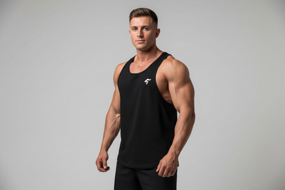 Muscular man wearing a black tank top with a logo on a gray background