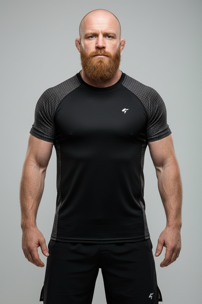 Man wearing a black athletic outfit with a logo on a gray background