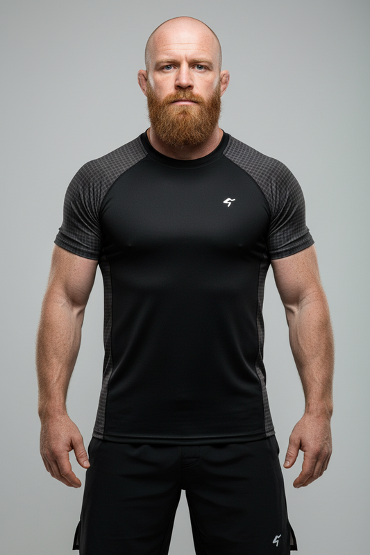 Man wearing a black athletic outfit with a logo on a gray background