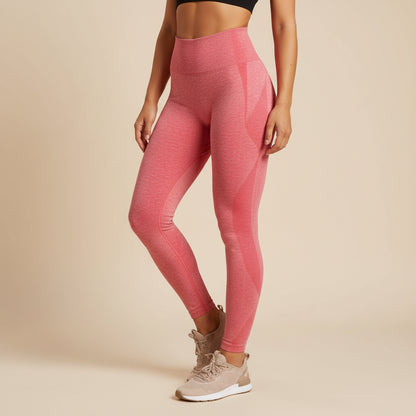Person wearing pink leggings and beige sneakers on a beige background