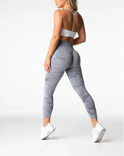 Person wearing gray leggings and white sneakers on a white background