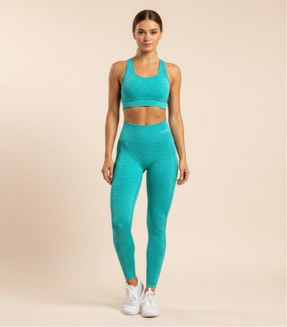 Teal leggings folded on a black and gray striped surface