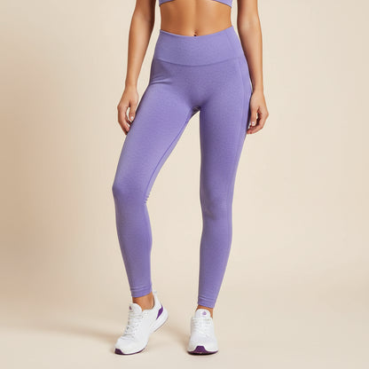 Person wearing purple leggings and white sneakers on a beige background