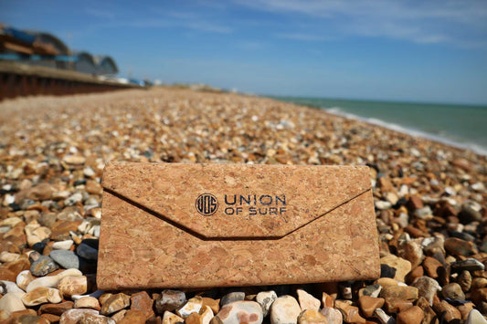 Cork sunglasses case with snap flap and UNION OF SURF logo, shown closed