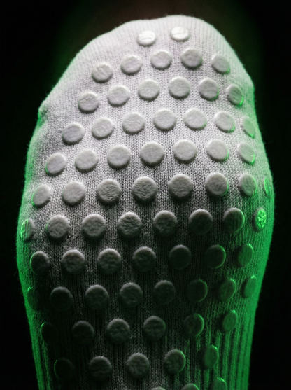 Close-up of white sock sole with raised non-slip grip dots