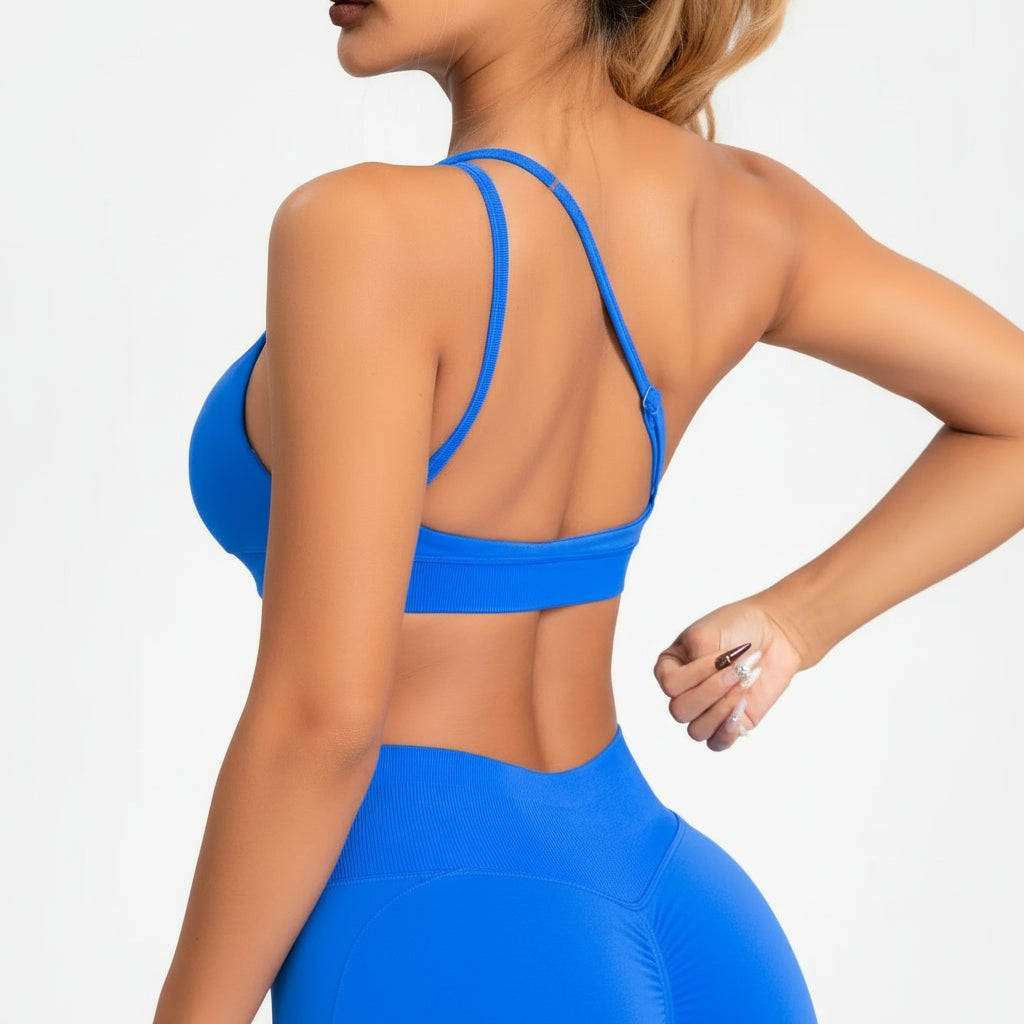 Person wearing a blue sports bra and shorts on a white background