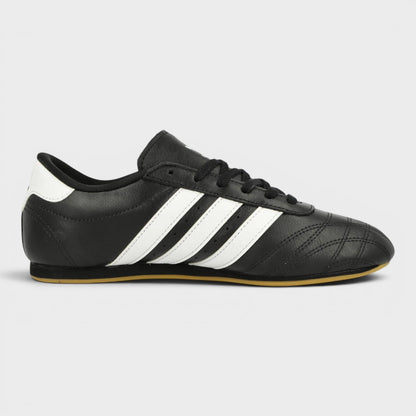 Black taekwondo shoes with three white stripes and lace-up front
