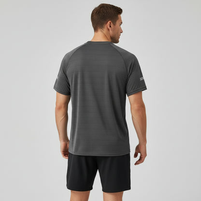 Dark gray t-shirt on a hanger against a dark gray background