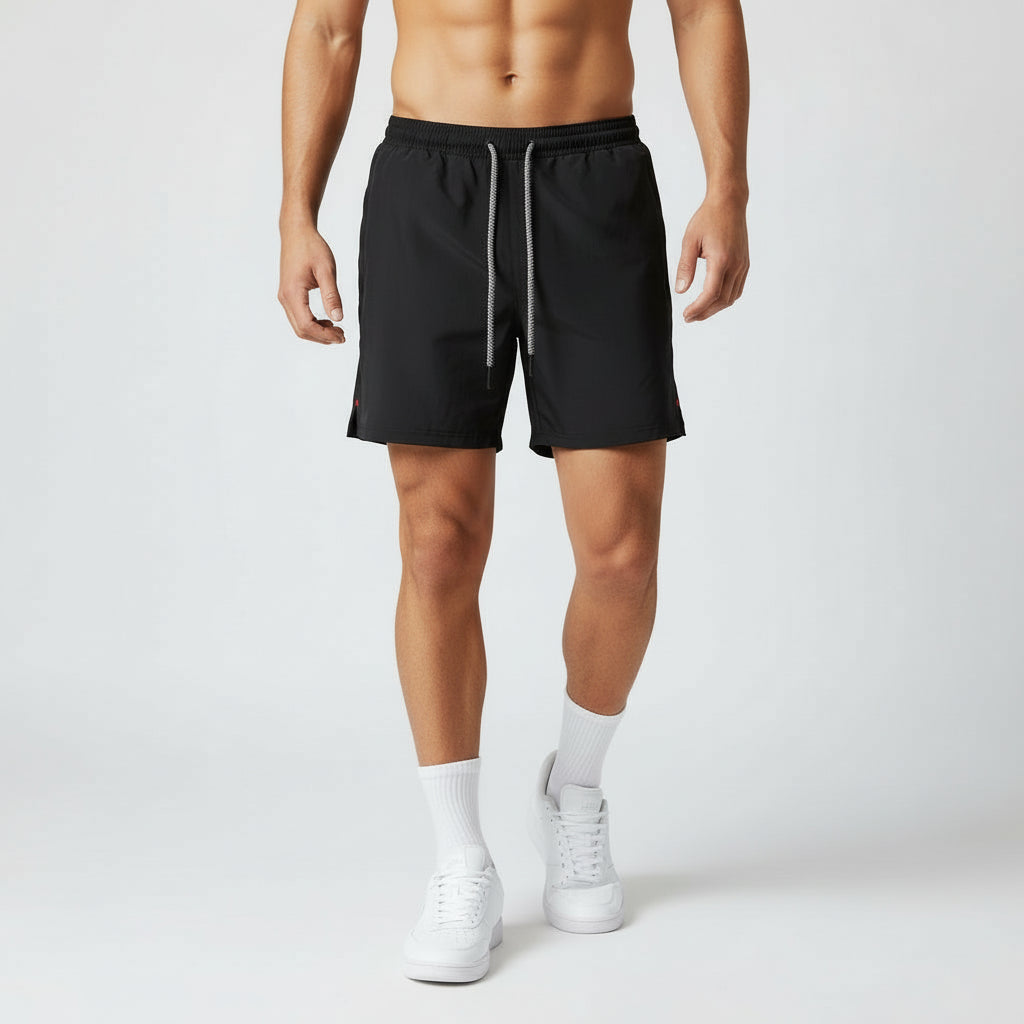 Person wearing black shorts on a white background