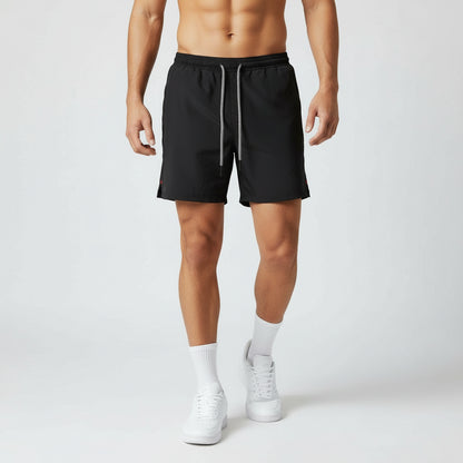Person wearing black shorts on a white background
