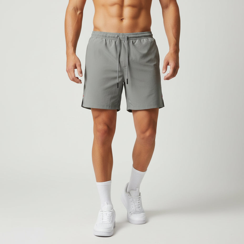 Person wearing gray shorts on a plain background
