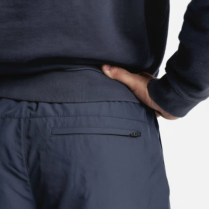 Navy blue sweater and pants worn by a person on a white background