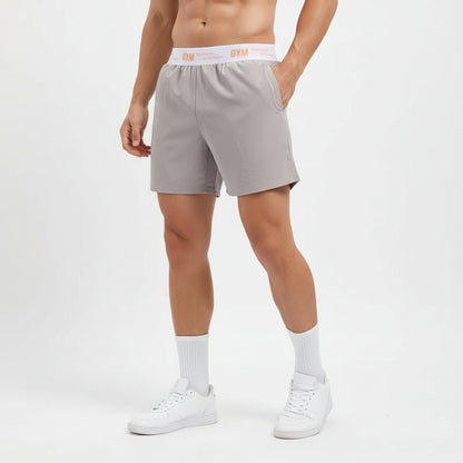 Person wearing gray shorts with a white background