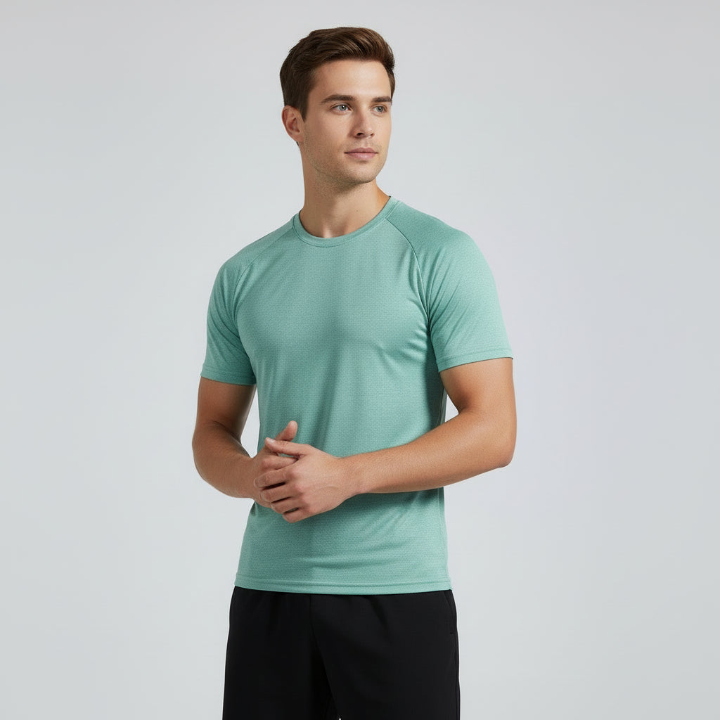 Man wearing a light green t-shirt against a plain background