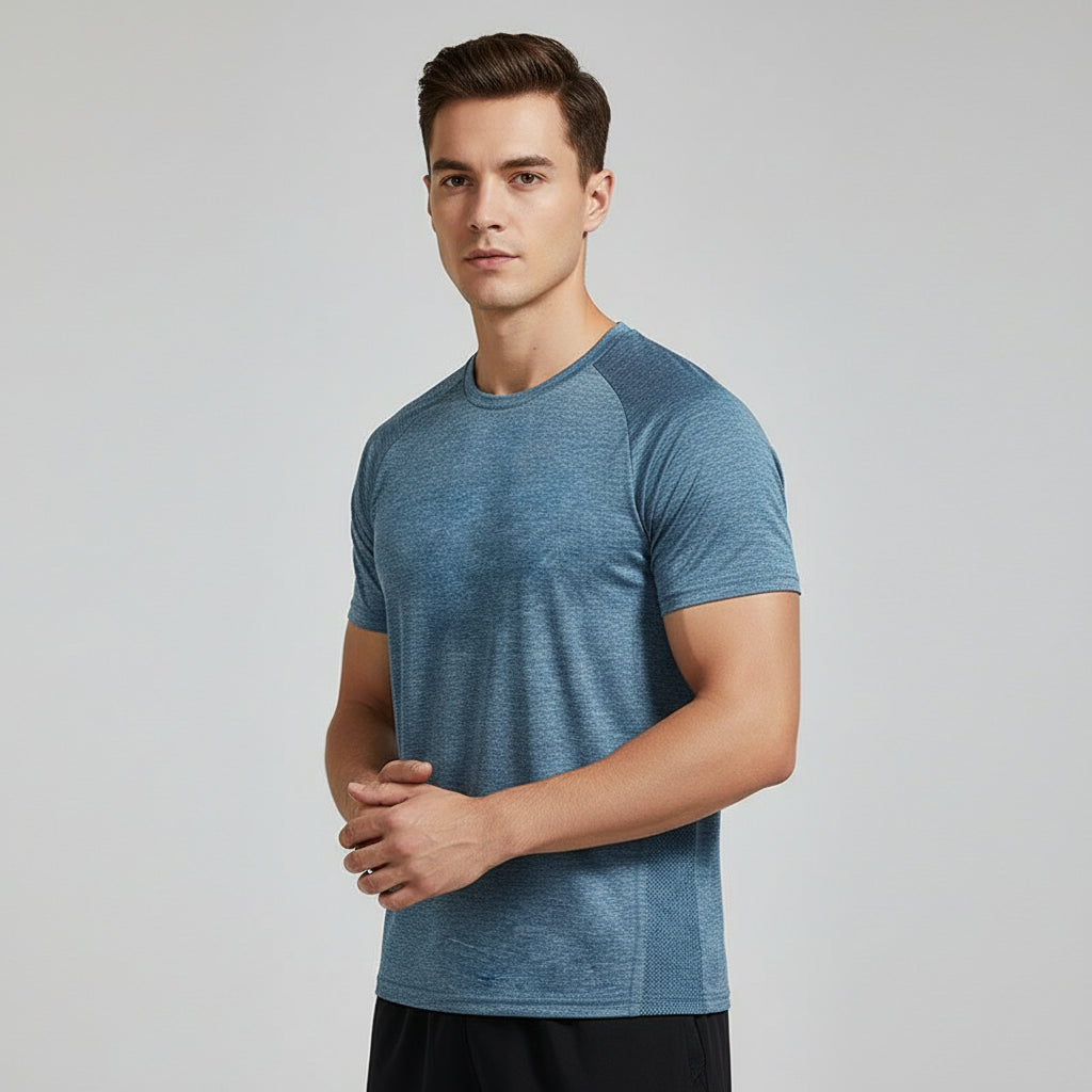 Man wearing a blue athletic shirt on a gray background