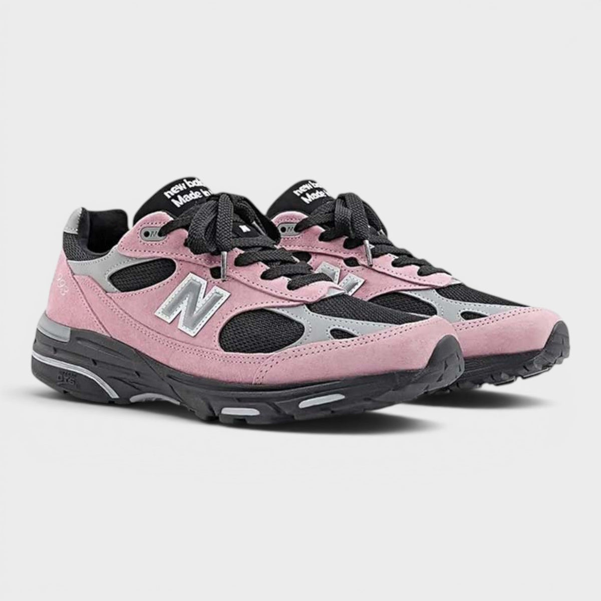 Pink and gray New Balance sneakers, side-by-side view with black laces and 'N' logo